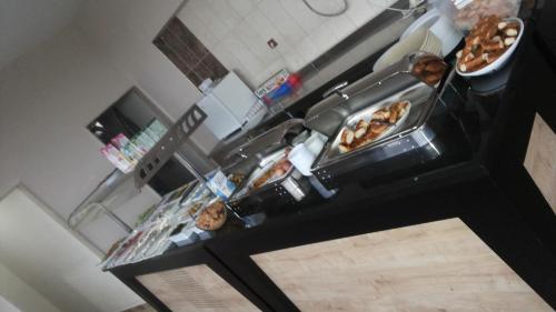 an overhead view of a counter with many different types of food at Waha Hotel in Bursa