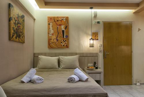 a bedroom with a bed with two pillows on it at Orange Central Studio Heraklion in Heraklio