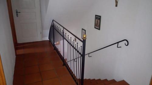 a stairway with a black railing next to a door at Casa De Campo Ladestation E - Auto neu renoviert in Trabelsdorf