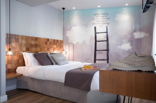 a bedroom with a bed with a ladder on the wall at Apollon Library Suites in Nafpaktos