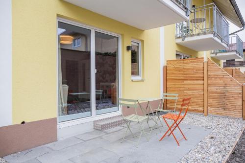 a patio with a table and chairs outside of a house at HOMEBOUND APARTMENTS Salzburg City II - contactless check-in in Salzburg