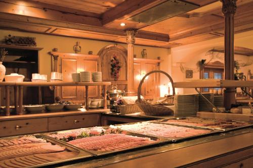 a kitchen with a counter with some food on it at Sattelbogener Hof in Traitsching