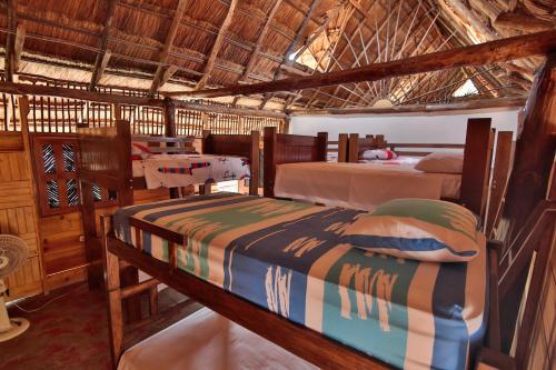 Кровать или кровати в номере Hostal Nibuni Palomino