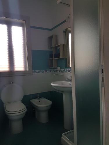 a bathroom with a toilet and a sink at La Porta dell'Alcantara in Gaggi