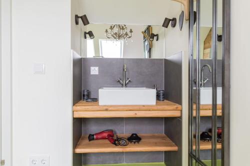 a bathroom with a sink and a mirror at HOMEBOUND APARTMENTS Salzburg City II - contactless check-in in Salzburg