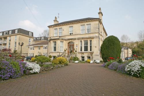 a large house with a brick driveway in front of it at Pulteney House in Bath