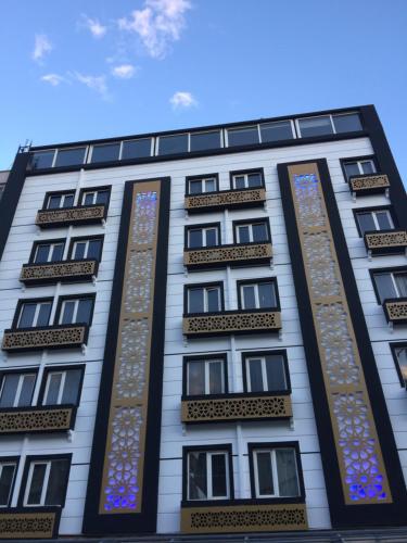 a tall white building with stained glass windows at Grand Kayalar Hotel in Antalya