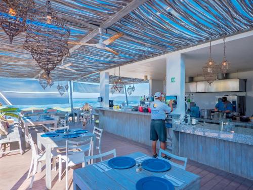 a person standing at the counter of a restaurant at Suites at Sapphire Ocean Club in Puerto Vallarta