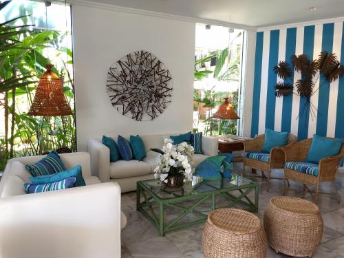 a living room with blue and white striped walls at Ubatuba Palace Hotel in Ubatuba