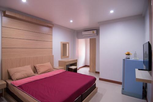 una camera da letto con un grande letto con una coperta rossa di TN Thanyawit a Nakhon Ratchasima