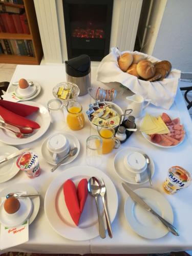 a table with plates of breakfast food on it at Appartement Hotel Marien-Hof in Vienna