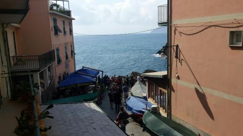 a group of people walking down a street between two buildings at Casa LA MARINA in Manarola