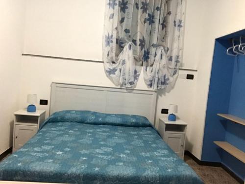 a bedroom with a bed and two night stands at Casa LA MARINA in Manarola