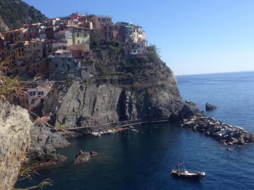 a group of houses on a cliff next to the water at Casa LA MARINA in Manarola