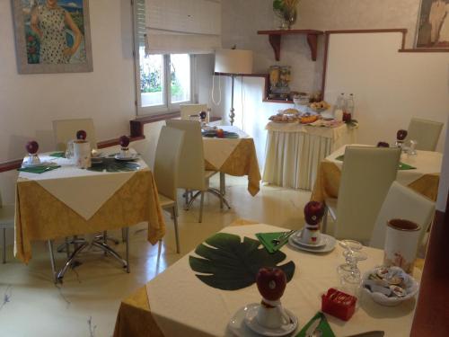 a room with tables and chairs with food on them at Hotel Derby in Bellaria-Igea Marina