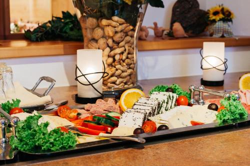 a tray of food on a table with vegetables and meat at Familien- und Wellnesshotel "Landhaus Viktoria" in Oberstdorf