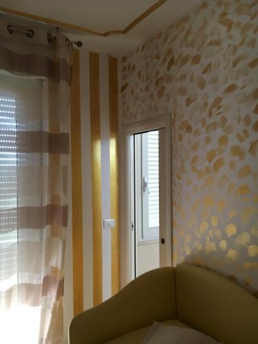 a living room with a couch and a window at Hotel Derby in Bellaria-Igea Marina