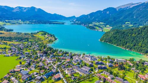 an aerial view of a town next to a lake at Hotel Seerose Wolfgangsee in St. Wolfgang