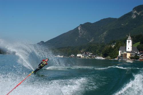 a person is water skiing in a lake at Hotel Seerose Wolfgangsee in St. Wolfgang
