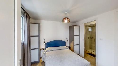 a bedroom with a bed and a blue chair at B&B Bessy 10 in Antibes