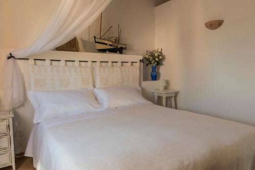 a bedroom with a white bed with a white canopy at CelesteDiMare in Palau