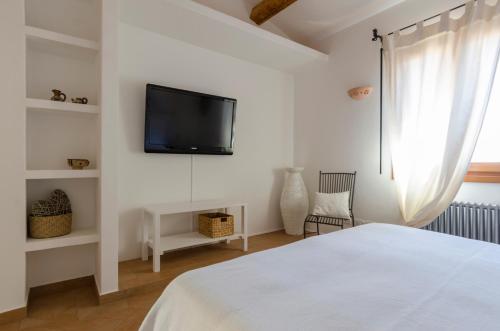 a bedroom with a bed and a tv on a wall at CelesteDiMare in Palau