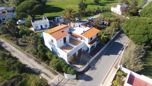 an overhead view of a large white house with orange roofs at Casas Típicas Algarvias in Arroteia de Baixo