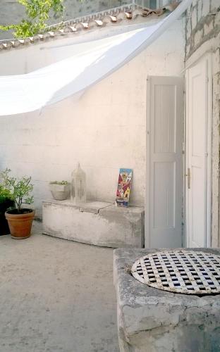 a porch with a white door and a window at Luxury Apartment In The Old Palace in Sutivan