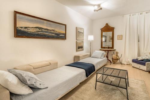ein Schlafzimmer mit einem Bett, einem Sofa und einem Tisch in der Unterkunft Luxury Apartment In The Old Palace in Sutivan