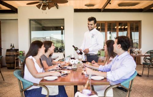 a group of people sitting around a table in a restaurant at Hotel Terraviña in Santa Cruz