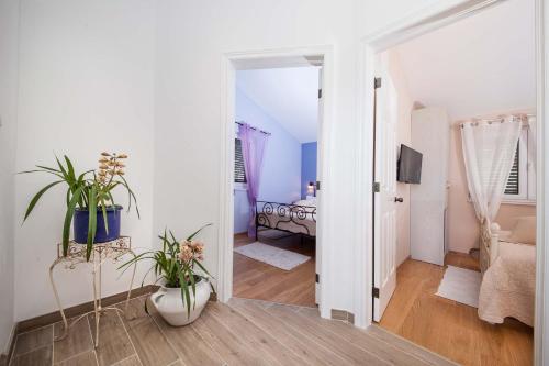 a room with a door open to a bedroom at Old stone house Mario in Podgora