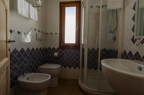 a bathroom with a toilet and a sink and a shower at CelesteDiMare in Palau