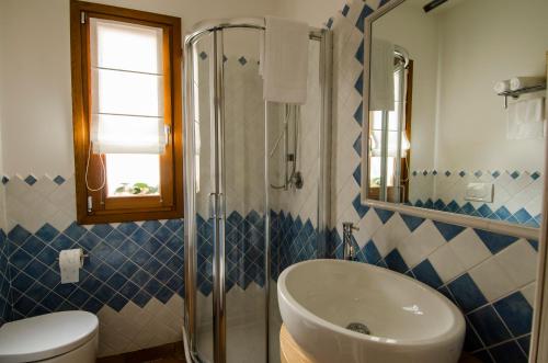 a bathroom with a sink and a toilet and a shower at CelesteDiMare in Palau