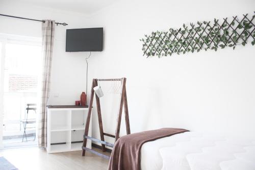 
a bedroom with a bed and a dresser at Easy4Stay in Portimão
