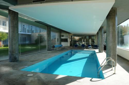 a swimming pool in the middle of a house at Hotel Turismo De Trancoso in Trancoso