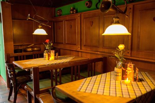 a kitchen with two tables and chairs and two lights at Braugasthof Trompete in Eichstätt