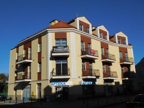 a large building with a sign on the side of it at Apartament DERUBEIS in Wieliczka