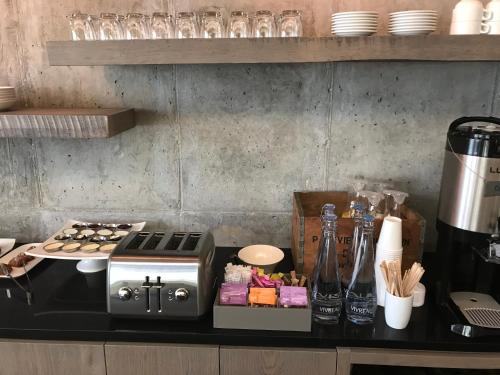 a kitchen with a counter with a stove top oven at The Preston House and Hotel in Riverhead