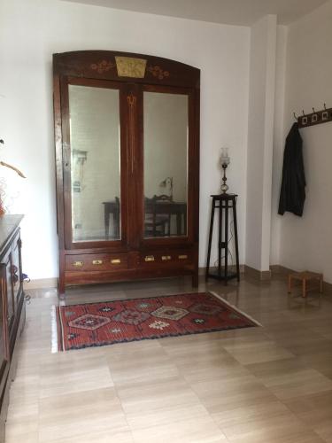 a room with a large wooden door and a rug at A casa di Gio in Lecce