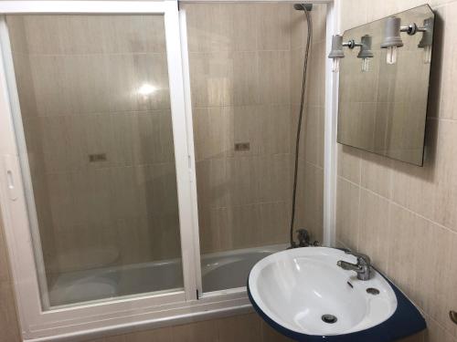 a bathroom with a shower and a sink at Olinda’s Rooms in Lagos