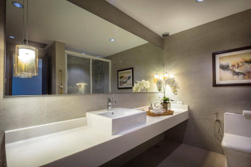 a bathroom with a white sink and a mirror at Dalian Peak Hotel in Angeles