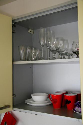 a shelf with wine glasses and bowls on it at Luxury apartment in the heart of the capital in Kyiv