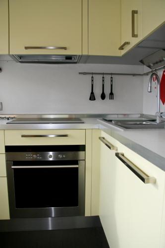 a kitchen with a black oven and white cabinets at Luxury apartment in the heart of the capital in Kyiv