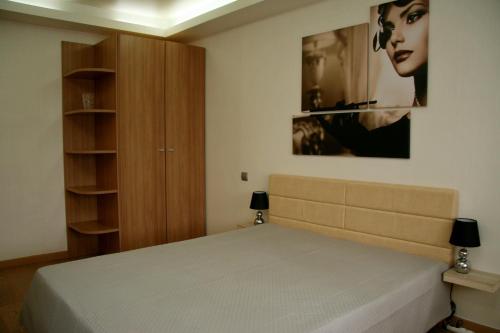 a bedroom with a large bed and a cabinet at Luxury apartment in the heart of the capital in Kyiv