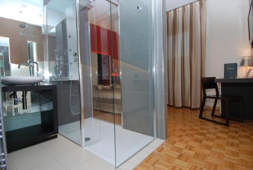 a glass shower in a bathroom with a sink at Hotel La Pergola in Grezzana