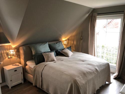 a bedroom with a large bed and a window at Neptun17 in Scharbeutz