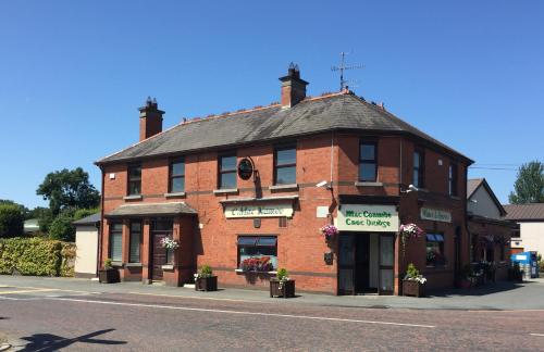 a large brick building on the corner of a street at The Village Rooms in Dundalk