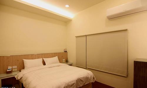 Katil atau katil-katil dalam bilik di 綠島 綠堤濱海旅店