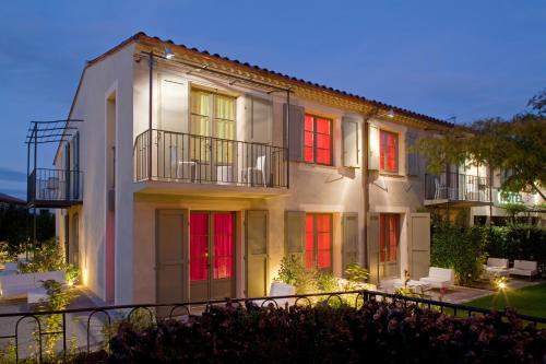 a large white building with colorful windows at night at Hôtel Montmorency & Spa in Carcassonne