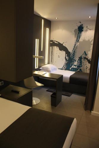 a bedroom with two beds and a painting on the wall at Arc de Triomphe Etoile in Paris